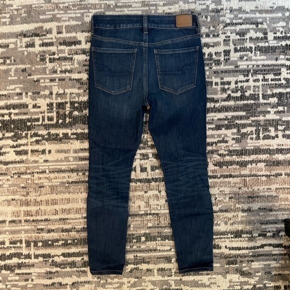 American Eagle | Highrise Next Level Stretch Destressed Dark Blue Jean - Picture 11 of 11